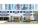 A stylish building entrance features an American flag, glass doors, and covered parking at 101 S Gulfstream Ave # 16C, Sarasota, FL 34236