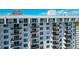 Modern apartment building featuring multiple balconies, glass railings, and a sleek white facade for stylish waterfront living at 101 S Gulfstream Ave # 16C, Sarasota, FL 34236