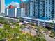 Beautiful view of a condominium complex featuring tropical landscaping and rooftop pool at 101 S Gulfstream Ave # 16C, Sarasota, FL 34236