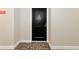 A close-up of the unit's front door, set against the neutral hallway, with patterned carpeting at 101 S Gulfstream Ave # 16C, Sarasota, FL 34236
