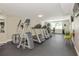 Fitness center with treadmills, elliptical machines, weights, and a wall-mounted TV at 101 S Gulfstream Ave # 16C, Sarasota, FL 34236