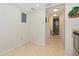Hallway leading to the laundry area and bathroom with tiled flooring at 101 S Gulfstream Ave # 16C, Sarasota, FL 34236