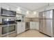 Modern kitchen with stainless steel appliances and white cabinets at 101 S Gulfstream Ave # 16C, Sarasota, FL 34236