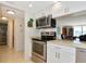 Kitchen with stainless steel appliances and a pass-through to the living area at 101 S Gulfstream Ave # 16C, Sarasota, FL 34236