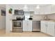 Well-lit kitchen with stainless steel appliances, white cabinets, and a view to the living space at 101 S Gulfstream Ave # 16C, Sarasota, FL 34236