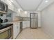 Kitchen equipped with stainless steel appliances, white cabinetry, and tile flooring at 101 S Gulfstream Ave # 16C, Sarasota, FL 34236