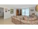 Spacious living room featuring a couch, bookshelves, and access to a balcony at 101 S Gulfstream Ave # 16C, Sarasota, FL 34236