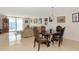 Open-concept living and dining area with city views, tile flooring and a decorative chandelier at 101 S Gulfstream Ave # 16C, Sarasota, FL 34236