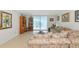 Cozy living room with a couch, zebra rug, bookcase, and access to a balcony at 101 S Gulfstream Ave # 16C, Sarasota, FL 34236