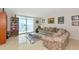Bright living room with a couch, zebra rug, bookcase, and balcony with a view at 101 S Gulfstream Ave # 16C, Sarasota, FL 34236