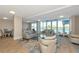 Bright living room with neutral tones, tile flooring, modern furniture and large glass doors with views at 101 S Gulfstream Ave # 16C, Sarasota, FL 34236