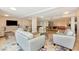Spacious lounge featuring modern seating arrangements, a central glass table, and communal dining areas at 101 S Gulfstream Ave # 16C, Sarasota, FL 34236