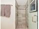 Modern bathroom shower with pebble floor, custom tile, and glass door at 101 S Gulfstream Ave # 16C, Sarasota, FL 34236