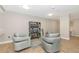 Sitting area with stylish chairs, bookcase, and neutral decor at 101 S Gulfstream Ave # 16C, Sarasota, FL 34236