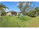 Expansive backyard with a hammock, mature trees, and a screened lanai at 11835 Crawford Parrish Ln, Parrish, FL 34219