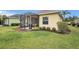 A well-kept backyard with a screened lanai and lush green grass at 11835 Crawford Parrish Ln, Parrish, FL 34219