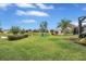 Lush backyard with pond view, Adirondack chairs, and relaxing hammock at 11835 Crawford Parrish Ln, Parrish, FL 34219