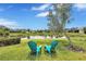 Scenic view of a tranquil pond from the backyard with two Adirondack chairs at 11835 Crawford Parrish Ln, Parrish, FL 34219