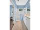 Well-lit bathroom showcases blue accent walls, a walk-in shower and white cabinets at 11835 Crawford Parrish Ln, Parrish, FL 34219