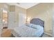 Comfortable bedroom featuring a quilted bed, window, closet, and doorway to another room at 11835 Crawford Parrish Ln, Parrish, FL 34219