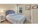 Cozy bedroom with a plush bed, soft lighting, and neutral decor at 11835 Crawford Parrish Ln, Parrish, FL 34219