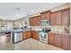 Well-equipped kitchen with stainless steel appliances and wood cabinets at 11835 Crawford Parrish Ln, Parrish, FL 34219