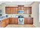 Efficient kitchen with stainless steel range and ample wood cabinetry at 11835 Crawford Parrish Ln, Parrish, FL 34219
