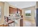Well-lit kitchen featuring a breakfast bar and dark wood cabinets at 11835 Crawford Parrish Ln, Parrish, FL 34219