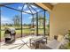 Inviting lanai with outdoor seating and a grill, perfect for enjoying the beautiful backyard scenery at 11835 Crawford Parrish Ln, Parrish, FL 34219