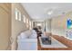 Bright living room featuring hardwood floors, a white sofa and backyard view at 11835 Crawford Parrish Ln, Parrish, FL 34219
