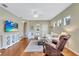 Bright and airy living room with hardwood floors and cozy seating arrangement at 11835 Crawford Parrish Ln, Parrish, FL 34219