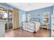 Serene bedroom featuring wood floors and sliding glass door to the outdoors at 11835 Crawford Parrish Ln, Parrish, FL 34219