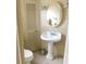 Bathroom featuring a pedestal sink, toilet, and wood-paneled walls at 1212 45Th E Ave, Ellenton, FL 34222