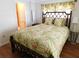Comfortable bedroom features an ornate bed frame with bright tropical bedding at 1212 45Th E Ave, Ellenton, FL 34222