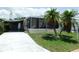 Charming home with a covered carport and a screened-in porch, complemented by palm trees at 1212 45Th E Ave, Ellenton, FL 34222