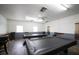 Community game room with two pool tables and ceiling fan at 1212 45Th E Ave, Ellenton, FL 34222