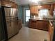 Kitchen with stainless steel appliances and wooden cabinetry at 1212 45Th E Ave, Ellenton, FL 34222