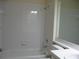 Bright bathroom features a tub/shower combo with white tile surround at 12301 Mosswood Pl, Lakewood Ranch, FL 34202