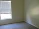 Neutral bedroom featuring bright light from a window and soft neutral walls at 12301 Mosswood Pl, Lakewood Ranch, FL 34202