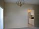 Open dining room area with view of kitchen and decorative chandelier at 12301 Mosswood Pl, Lakewood Ranch, FL 34202