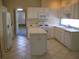 Well-lit kitchen with ample counter space, white appliances, and tile floors at 12301 Mosswood Pl, Lakewood Ranch, FL 34202