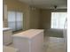 Open kitchen featuring tile floors and an island with views of the living room at 12301 Mosswood Pl, Lakewood Ranch, FL 34202
