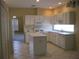 Well-lit kitchen with ample counter space, white appliances, and tile floors at 12301 Mosswood Pl, Lakewood Ranch, FL 34202