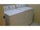 A washer and dryer sit side by side in this home's laundry area at 12301 Mosswood Pl, Lakewood Ranch, FL 34202