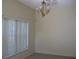 Bright room with carpeted floors, large window, and decorative chandelier at 12301 Mosswood Pl, Lakewood Ranch, FL 34202