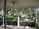 This screened-in porch features verdant landscaping and neighborhood views at 12301 Mosswood Pl, Lakewood Ranch, FL 34202