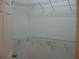 Walk-in closet with white wire shelving and a door ajar at 12301 Mosswood Pl, Lakewood Ranch, FL 34202