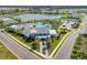 Aerial view of community clubhouse, pool, lake, and surrounding homes at 13918 Old Creek Ct, Parrish, FL 34219