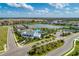 Aerial view of community with lake, pool, clubhouse, and lush landscaping at 13918 Old Creek Ct, Parrish, FL 34219