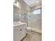 Bright bathroom featuring a glass shower, a white vanity, and coastal decor at 13918 Old Creek Ct, Parrish, FL 34219